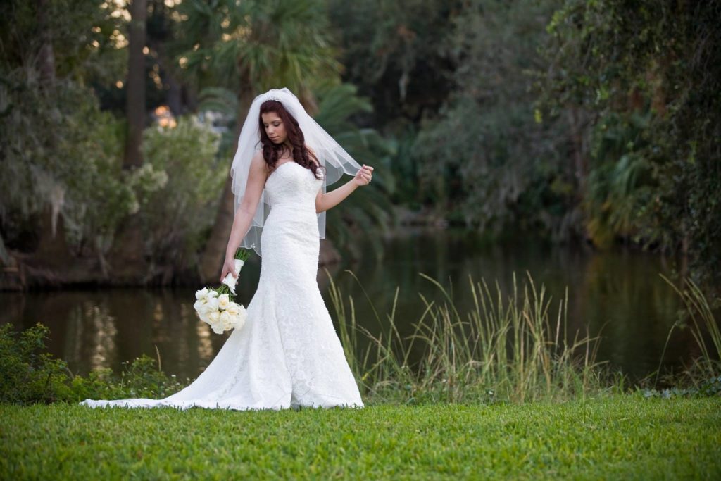 Bride standing in front of a pond