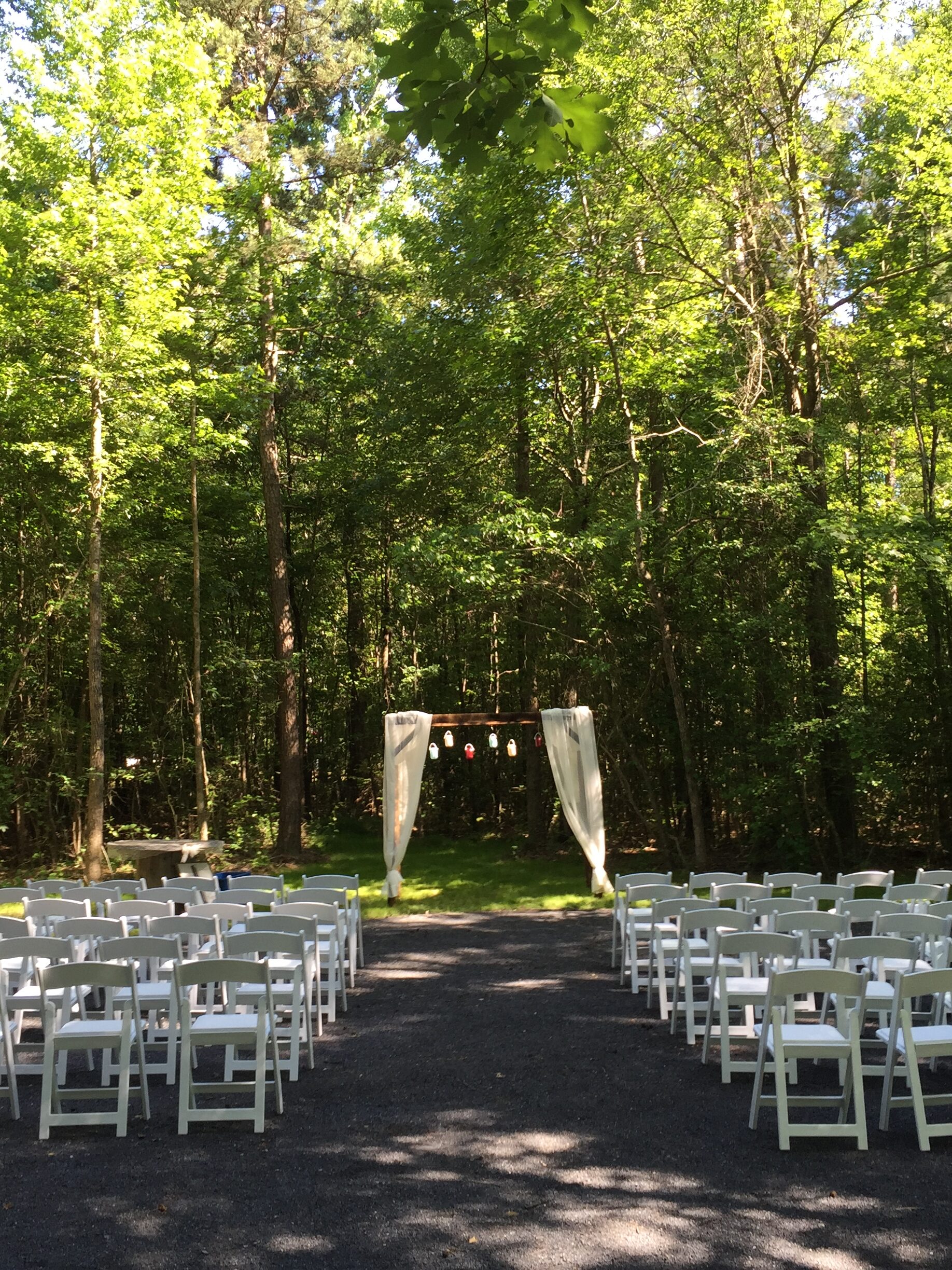 outdoor wedding ceremony under beautiful trees at Avalon Keep Botanical Gardens